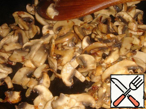 Add the mushrooms cut into strips, add salt to let the mushrooms juice and fry until the mushrooms acquire a Golden hue.
Remove the fried mushrooms from the heat and cool.