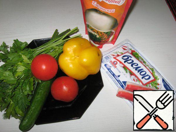 Prepare the ingredients for the salad: wash the vegetables.