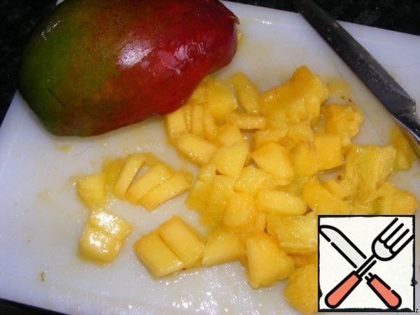 Peel and cut the mango into cubes.