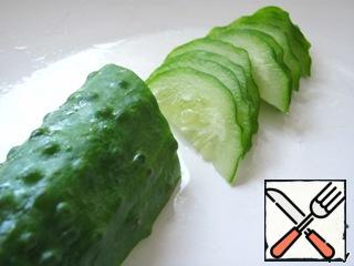 Cut the cucumber in half lengthwise, then cut diagonally.