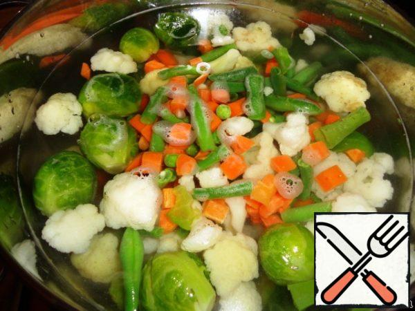 Throw the vegetables into salted boiling water and cook until tender.
You don't need to digest them, let them crunch a little.