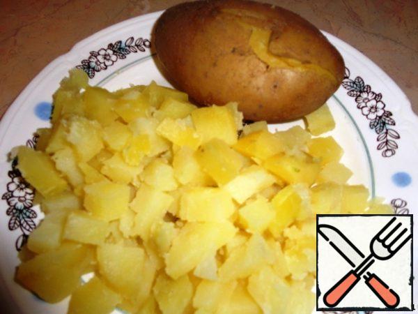 Boil the potatoes and cut them into small cubes.