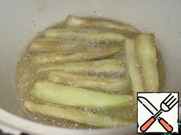 Fry the eggplant sticks in vegetable oil.