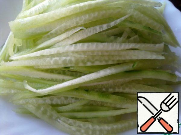 Peel the cucumbers and grate them on a Korean grater or simply cut into thin strips.