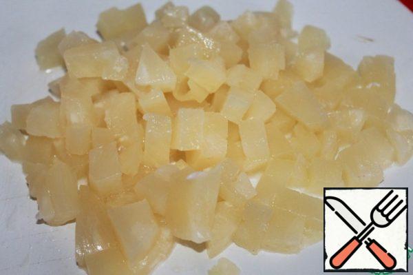 Cut canned pineapples into cubes.