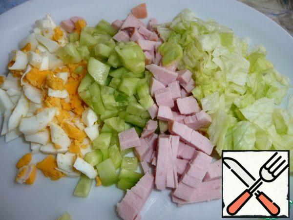 All products for salad cut into cubes.