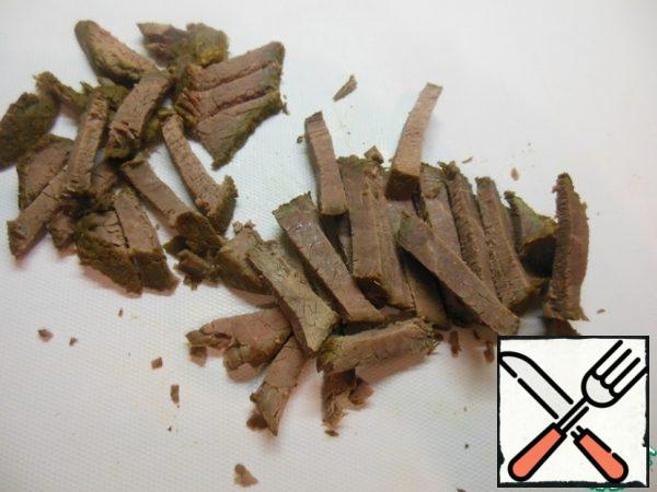 Cut the beef into strips.