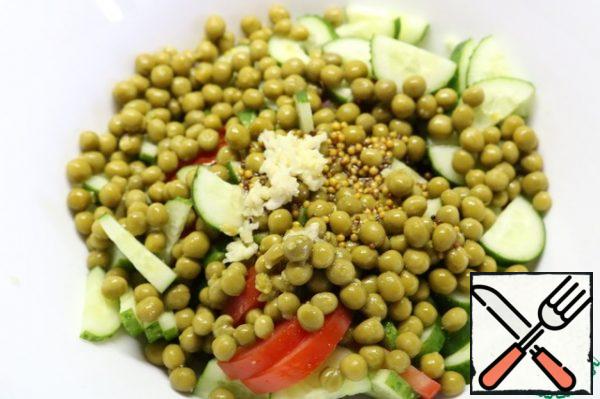 Pour the dressing over our vegetables. Add the chopped garlic.