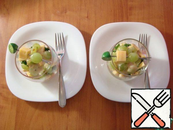 She put the skewers on top of the glasses and served them on the table.