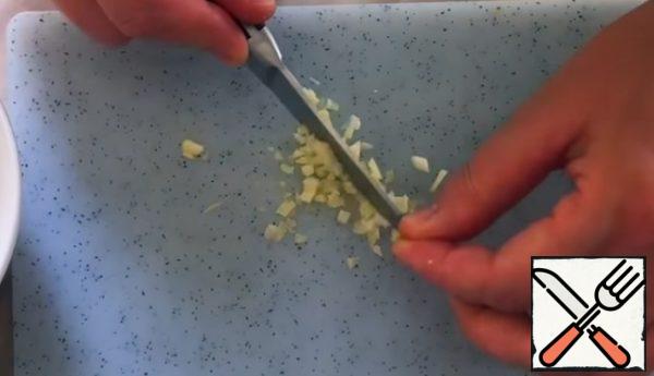 for the dressing, crush and finely chop the garlic clove.