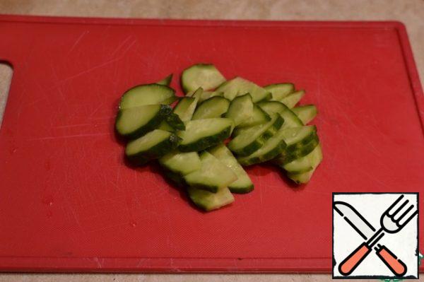 Pickled and fresh cucumbers cut lengthwise into 4 parts, and then into pieces.