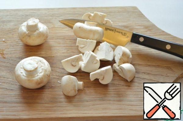 Wipe raw mushrooms with a dry clean cloth or napkin and cut into quarters.