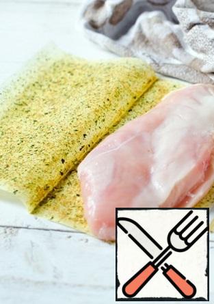 Chop off the chicken breast and carefully put it on a sheet for frying.