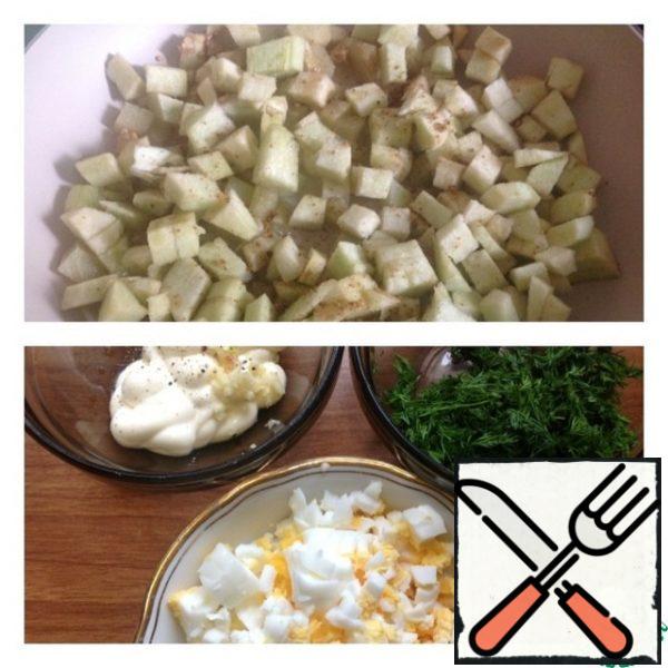 Peel the eggplant and cut it into small cubes.
Fry the eggplants in vegetable oil (in a small amount) with the addition of salt (preferably Svan, Adyghe or basil) and hops-suneli.
Place the finished eggplants on paper napkins to remove excess oil.
Meanwhile, cut the eggs into small cubes and chop the dill.
In a cup, mix mayonnaise, a mixture of peppers and garlic, passed through a press. Mix our dressing.