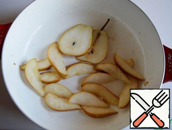 In the same pan, lightly add the thinly sliced pear slices.