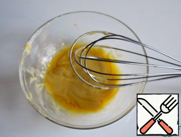 Gradually pour in the olive oil, whisking with a whisk until emulsified.