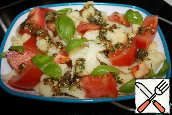 Mix the cabbage and tomatoes with the dressing.
Garnish with Basil leaves.