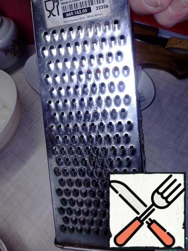 On the shallow side of the grater, RUB the garlic.