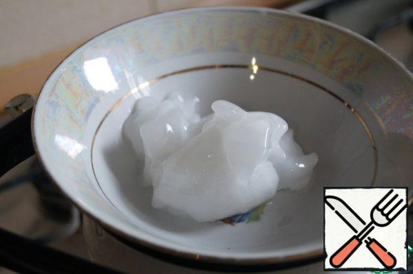 Pour coconut oil into a plate and melt it in a water bath.