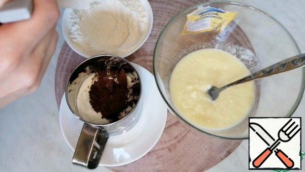 Then add half the flour, cocoa and baking powder to the sieve.