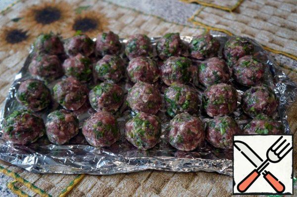 Wetting your hands in cold water, roll meatballs the size of a walnut or slightly larger. Spread on paper or foil.