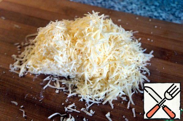 Grate the cheese on a coarse grater.