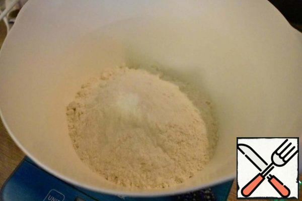 Knead the shortbread dough: chop the butter into pieces, mix in the crumbs with flour, add the yolk, salt, cold water, knead a homogeneous dough, wrap it in cling film, and put it in the refrigerator for 30 minutes.