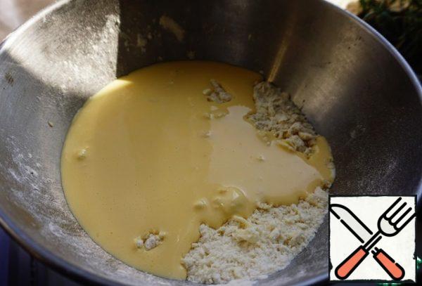 Pour the liquid ingredients to the flour and butter crumbs.