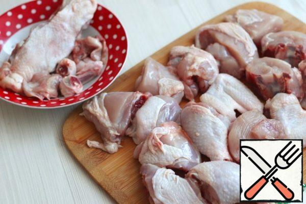 Cut out the vertebral part of the chicken carcass, remove the lower connecting joints of the chicken shins, and remove the upper part of the wings. All these parts can be further used in the preparation of broths and soups. cut the carcass into approximately identical pieces.