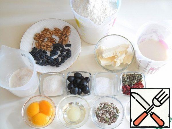 This is the abundance that you will need to make festive bread. All products should be warm, and the butter should be soft, the consistency of sour cream, warm it up a little.
In 50 ml of warm milk, dilute the yeast and a pinch of sugar, cover with a napkin and remove to a warm place so that they gain strength - become active.
Sift the flour. Separate the yolks from the whites and mix well without whipping. Nuts, seeds and raisins are sorted so that you don't get anything superfluous.