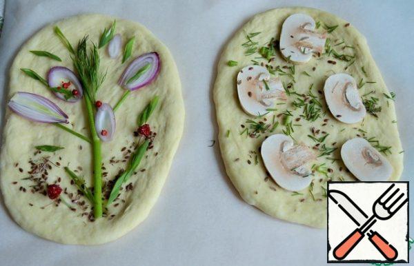 Shape the tortillas, stretching the dough with your hands, and decorate as desired and taste. For example, these.