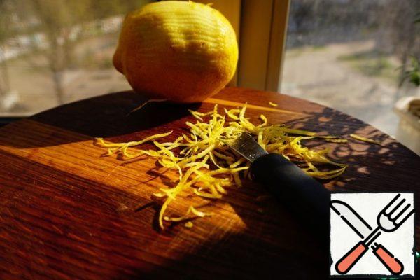 Start preparing the filling. Remove the zest from the lemon.
