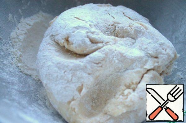 Knead the pliable dough. Add flour until it stops sticking to your hands and dishes.