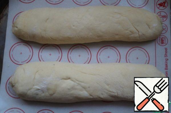 Then roll the tortilla into a roll. We will also do with the second part of the dough and the filling.