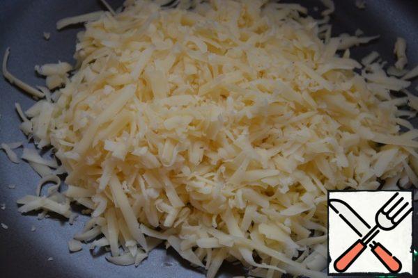 Grate the hard cheese.
