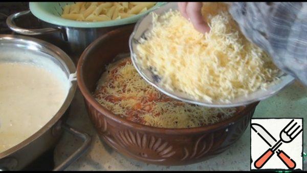 Sprinkle with oregano or Basil. Spread half the grated cheese.