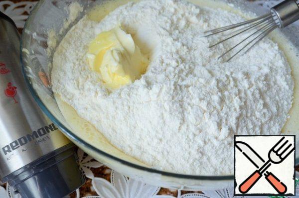 Sift the flour, mix with baking powder, and mix in the mixture with soft butter.