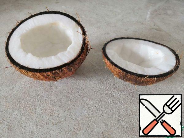 Open the coconut, tapping it with a knife.