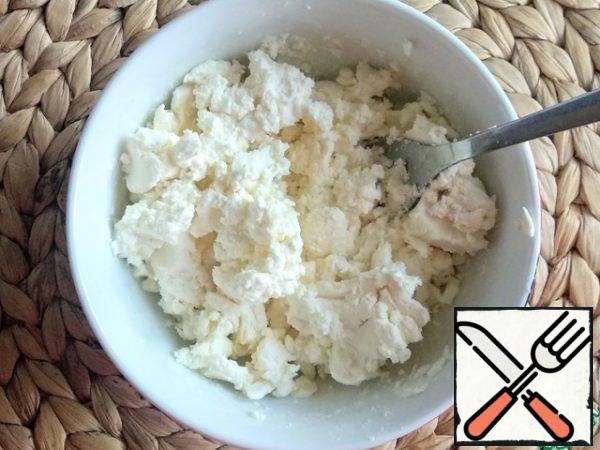 For the filling, mash the cheese with a fork.