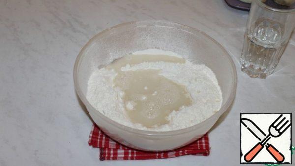 Add salt to the flour. Gradually add water and knead the dough.