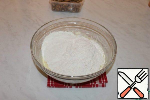 Add baking powder to the flour and mix well. Add the flour to the resulting mixture.