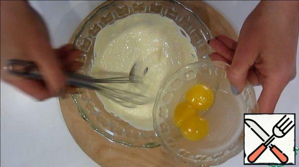 We prepare the dough.
Add sugar, egg yolks, slaked soda and flour to the softened butter.