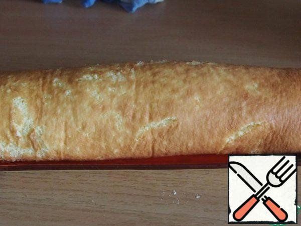Using a towel, roll up the roll and put it on the dish seam down.