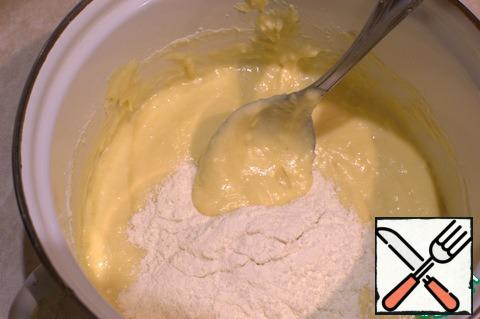Add the sifted flour mixed with baking powder, cream, and mix thoroughly.