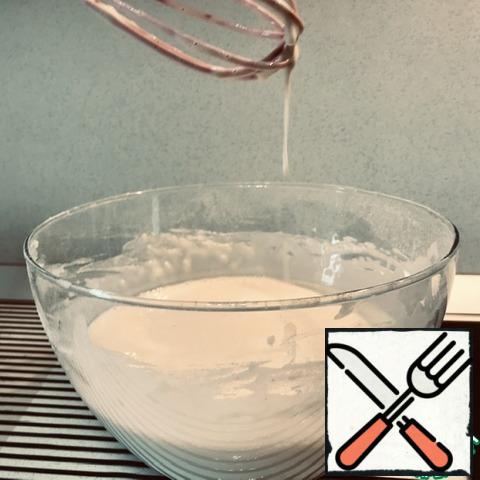 Prepare the ingredients, deep and medium bowls, whisk and sieve. Open the kefir, pour 1 glass from the pack and take it inside, put the rest of the package in the sink under a thin stream of warm water. Sausage and cheese to grate on a coarse grater, put them into a small bowl, cover from severiane and set aside in refrigerator. While you RUB the cheese with sausage, the kefir will become warm. Break the eggs, add a teaspoon of salt and a tablespoon of sugar (both without a hill), stir well, pour in the rest of the pack of kefir, stir again. Put a strainer over the resulting mixture, add flour with baking powder. To begin with, 1 Cup of flour, and then adjust the thickness of the dough after kneading. Gradually, when kneading, add more flour. I came up with another 2/3 Cup. The dough should remain liquid. A trickle runs down from the Corolla. Give the dough to stand for five minutes, meanwhile, put the pan to heat up on a small fire and choose what fat to fry. I prefer to fry in lard.