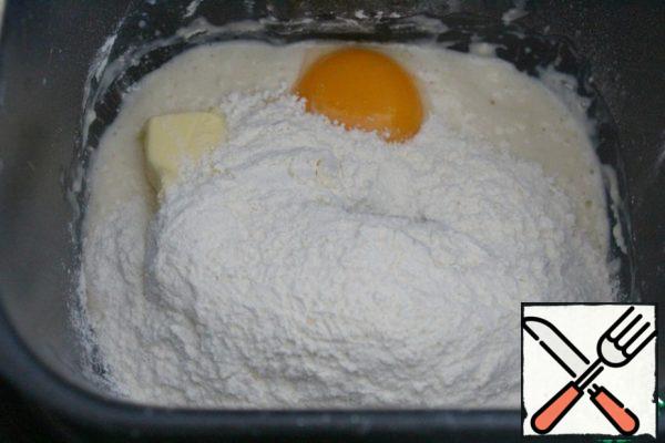 After 15 minutes, add the yolk, butter and 170 g of flour. Turn on the bread maker and the Dough (30 minutes of kneading plus 1 hour of proofing).
There are 30 grams of flour left - if the dough will stick a little after proofing, then add the rest of the flour - I did not add it.