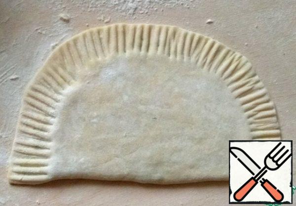 Fold in half, just slightly roll with a rolling pin to get rid of excess air. Secure the edges with a fork.