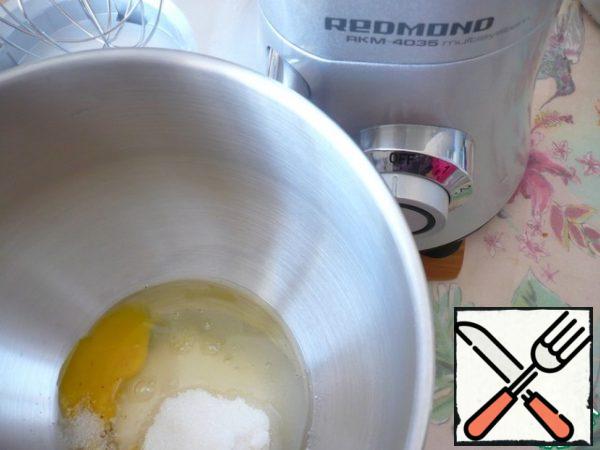 In the bowl of a glider mixer, combine the egg, add the remaining sugar and salt. Beat with a whisk attachment a