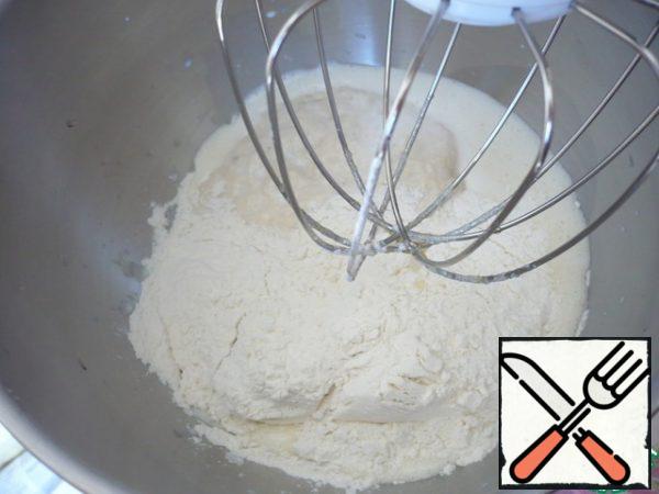 Add about half the flour.