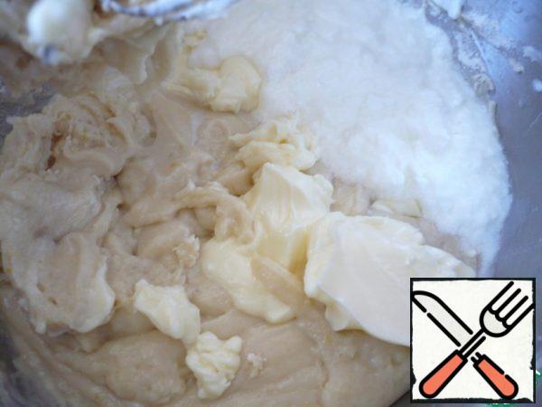 When it becomes quite problematic to knead the dough, then change the nozzle "whisk“ to ”hook". When all the flour is moistened, add the soft butter. Mix it into the dough and gradually pour in all the remaining flour. Flour may need a little more, 15-20 grams. Knead the dough at low speeds of the mixer for another 10-15 minutes. As the dough is kneaded, it becomes tender, soft and stops sticking to your hands (do not clog the dough with flour).